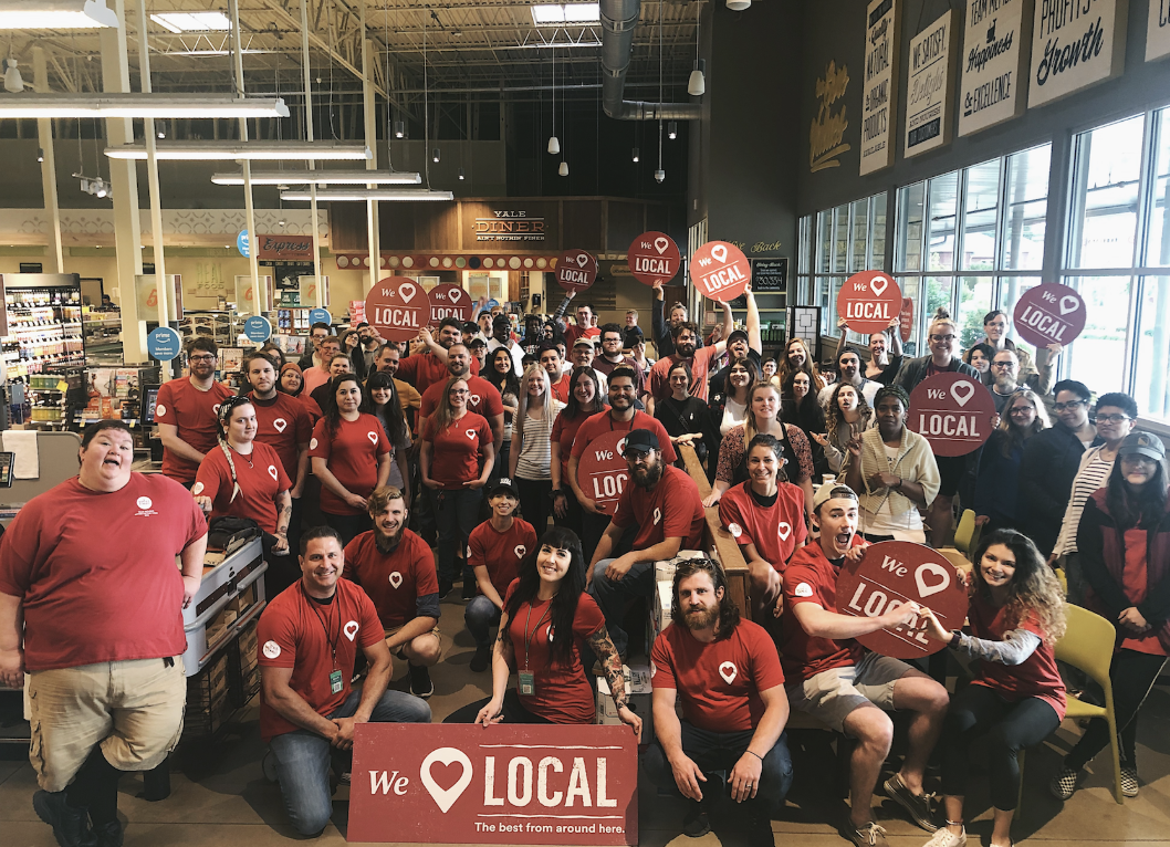 Whole Foods Market team gathered in matching We Love Local shirts